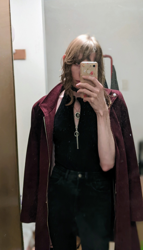 tall girl wearing long magenta coat over her shoulders